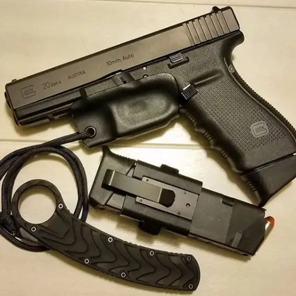 Field shot: Glock 20 with SureFire light and 15-round translucent magazine on rocky terrain