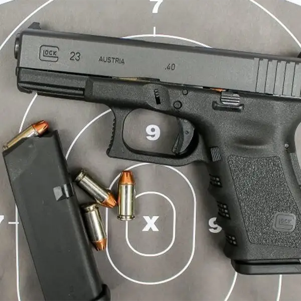 EDC flat-lay: Glock 23, spare magazine, tactical flashlight and folding knife