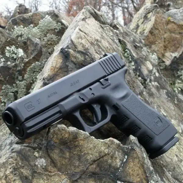 EDC flat-lay: Glock 37, spare mag, tactical flashlight and folding knife on canvas