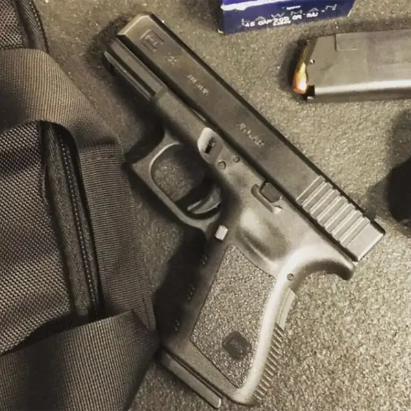 EDC flat-lay: Glock 38, spare magazine, tactical flashlight and folding knife