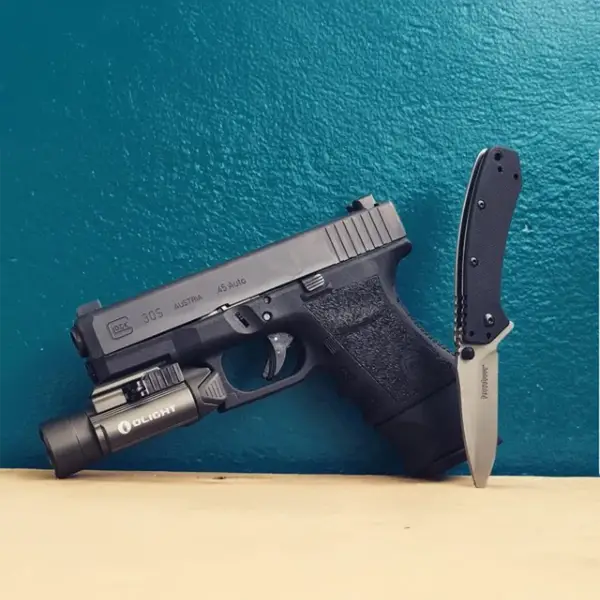 EDC flat-lay: Glock 30, spare 10-round mag, pocket light and folding knife