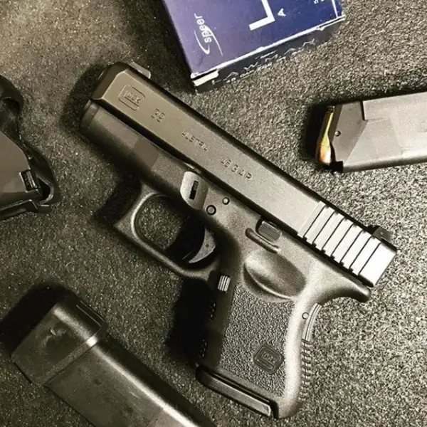 Outdoor shot: Glock 39 with six-round magazine on weathered timber