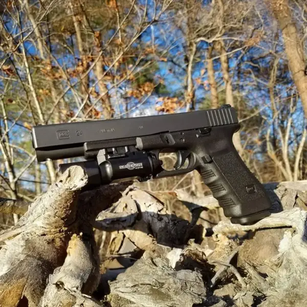Competition flat-lay: Glock 24, 22-round mag, magwell funnel and shot timer