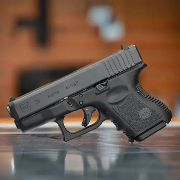 EDC flat-lay: Glock 39, spare six-round mag, pocket light and folding knife